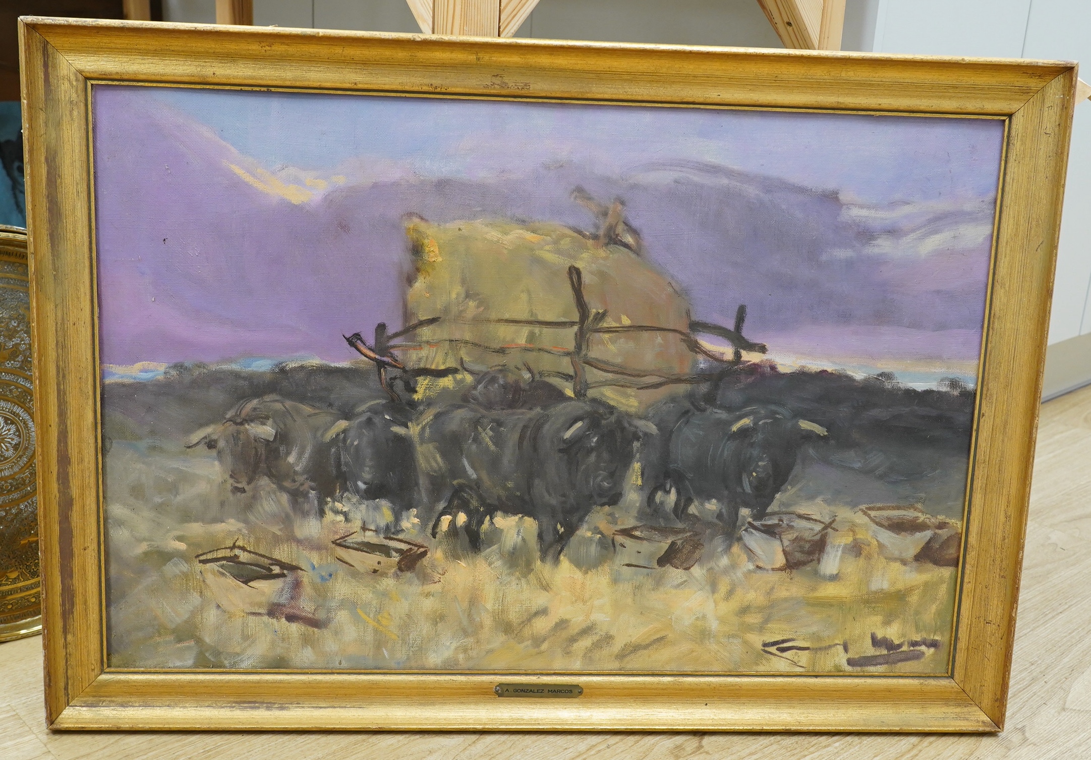 Angel Gonzalez Marcos (Spanish, 1900-1977), oil on canvas board, Oxen pulling a cart, signed, 52 x 82cm, applied plaque to the frame. Condition - fair, board warped